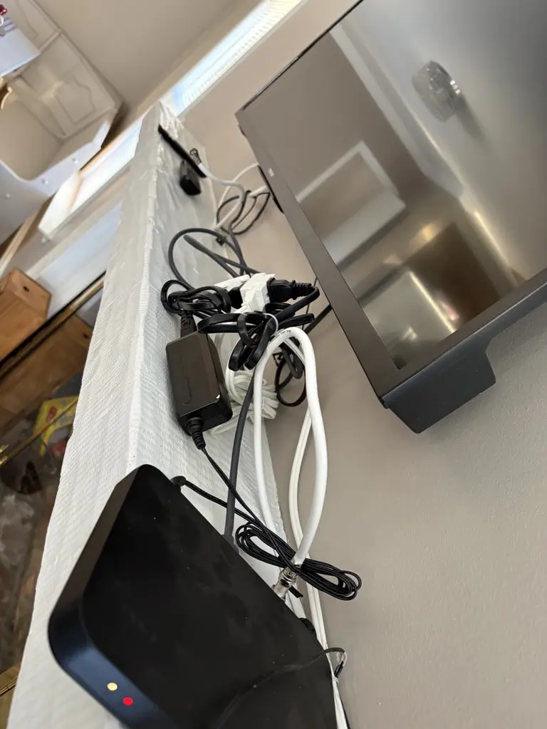 TV with cables and electronic devices.